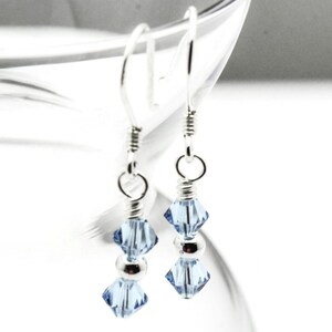 March Aquamarine Swarovski Crystal Birth Month Sterling Silver Drop Earrings hanging on vase