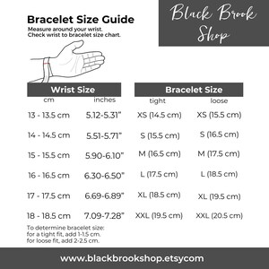 May include: A chart showing bracelet sizes in inches and centimeters. The chart includes a hand wearing a bracelet to illustrate wrist size. The chart also includes a table with bracelet sizes in inches and centimeters for both a tight and loose fit.