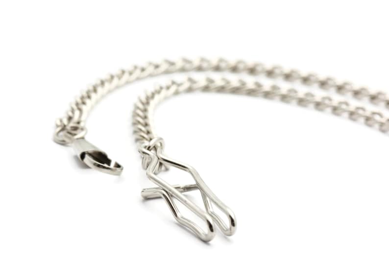 May include: A silver chain with a lobster clasp and a spring ring closure.