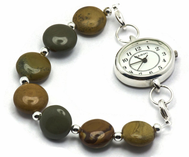 May include: A silver watch with a white face and black hands. The watch is attached to a bracelet made of brown and green stones.