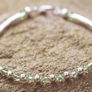 August Peridot Swarovski Crystal Birth Month Sterling Silver Plated Bracelet on stone