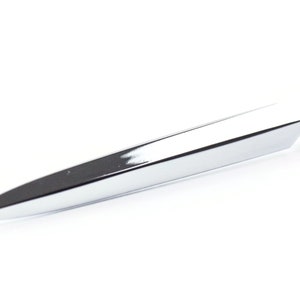 May include: A silver letter opener with a pointed tip and a rounded handle.