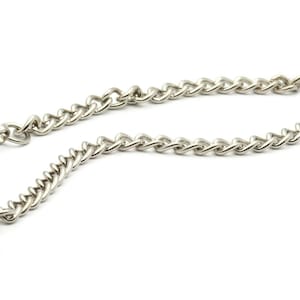 May include: A silver pocket watch with a chain attached. The watch has a round face and a silver chain with a clip.