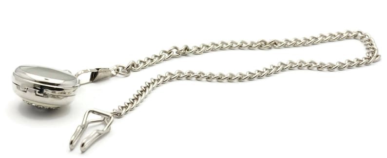 May include: A silver pocket watch with a chain attached. The watch has a round face and a silver chain with a clip.