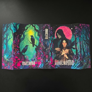 May include: A book cover with the title "Anathema" features a fantasy illustration. The artwork depicts a forest scene with ravens, a couple, and a pink moon. The color palette includes shades of blue, pink, and green.