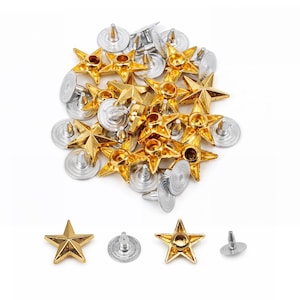 May include: A collection of star-shaped metal rivets featuring a gold-toned finish on the front and a silver-toned circular backing with a central post. The set includes multiple individual pieces arranged in a pile, with four separate components displayed below to show the front and back views.