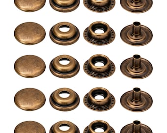 May include: A set of five antique brass metal snap fastener kits arranged in rows. Each kit includes a smooth domed cap, a socket, a stud with a perforated edge, and a post component. The hardware features a weathered, dark metallic finish.
