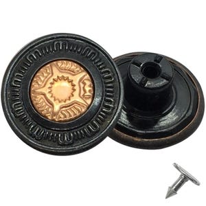 May include: Two dark bronze jean buttons with a decorative design and a copper-coloured centre. The buttons have a detailed pattern around the edge and a matching rivet. These buttons are ideal for denim jackets and jeans.