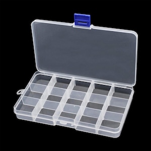May include: A rectangular, clear plastic storage box featuring a hinged lid with a blue latch. The interior is divided into fifteen individual compartments by fixed vertical and horizontal dividers, providing organised storage for small items.