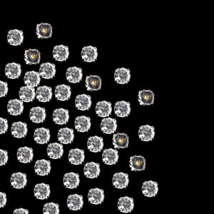 May include: A scattering of clear rhinestones with gold accents on a black background. The rhinestones are arranged in a loose, asymmetrical pattern.
