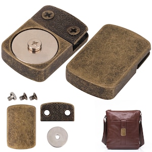 May include: A set of antique brass-toned metal magnetic bag clasps featuring a rectangular plate with a textured grid pattern, a circular silver-toned magnet, and small mounting screws, shown alongside a brown leather messenger bag.