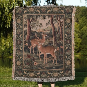 May include: A tapestry blanket depicting a forest scene with deer. The blanket has a dark green border with floral patterns and fringe. The text "Moon Ruler" is at the bottom.