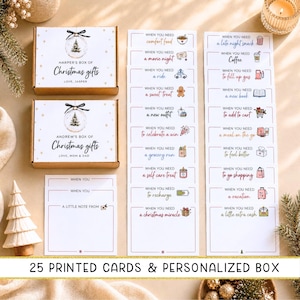 May include: Two rectangular cardboard gift boxes labeled Harper's Box of Christmas Gifts and Andrew's Box of Christmas Gifts, accompanied by twenty-five printed cards featuring various prompts like When You Need Comfort Food or A Christmas Miracle.