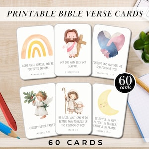 May include: Printable Bible verse cards featuring watercolor illustrations and inspirational quotes. The cards include images of a rainbow, Jesus, hands, an angel, a shepherd, and a crescent moon. The set contains 60 cards.