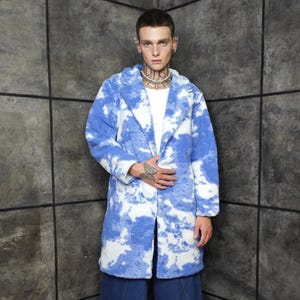 May include: A long, blue and white faux fur coat with a cloud-like pattern. The coat has a classic lapel collar and is worn over a white shirt and dark blue culottes. The person is wearing black boots.