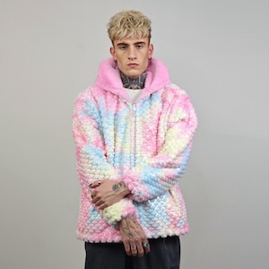 May include: A pink, blue, and yellow iridescent jacket with a zipper closure and a hood. The jacket has a textured, bubble-like design.