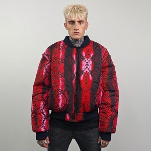 May include: A red and pink bomber jacket with a snake print pattern. The jacket has a zip closure and a ribbed collar, cuffs, and hem.