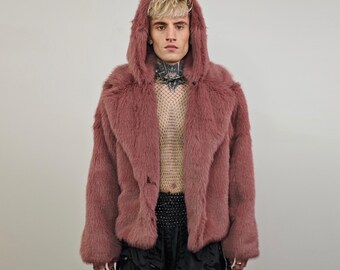 May include: A pink faux fur jacket with a hood. The jacket has a button closure and is made of soft, plush fabric.