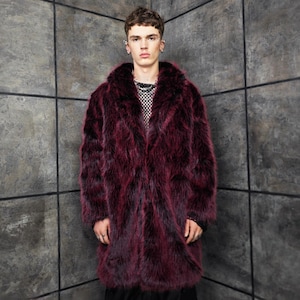 May include: A long, burgundy faux fur coat with a wide collar. The coat has a textured appearance and a dark, rich color. The coat is worn over a black and white mesh top.