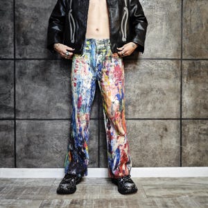 Express your bold style with these unisex paint splatter jeans, featuring vibrant colors and an edgy artistic vibe. Perfect for streetwear fans, skaters, festival goers, and creatives who love standout fashion. These jeans blend comfort with individuality, making them ideal for concerts, parties, raves, or everyday wear. A must-have for Y2K, grunge, and alternative fashion lovers seeking a unique wardrobe staple that turns heads and sets trends.