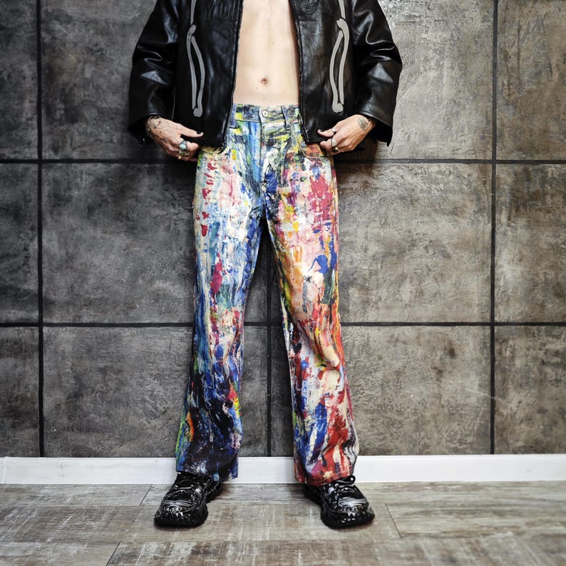 Express your bold style with these unisex paint splatter jeans, featuring vibrant colors and an edgy artistic vibe. Perfect for streetwear fans, skaters, festival goers, and creatives who love standout fashion. These jeans blend comfort with individuality, making them ideal for concerts, parties, raves, or everyday wear. A must-have for Y2K, grunge, and alternative fashion lovers seeking a unique wardrobe staple that turns heads and sets trends.