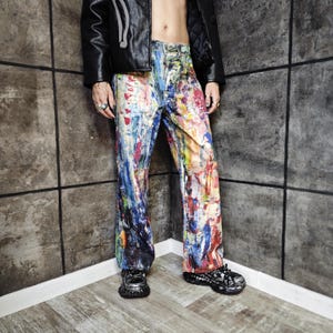 Express your bold style with these unisex paint splatter jeans, featuring vibrant colors and an edgy artistic vibe. Perfect for streetwear fans, skaters, festival goers, and creatives who love standout fashion. These jeans blend comfort with individuality, making them ideal for concerts, parties, raves, or everyday wear. A must-have for Y2K, grunge, and alternative fashion lovers seeking a unique wardrobe staple that turns heads and sets trends.