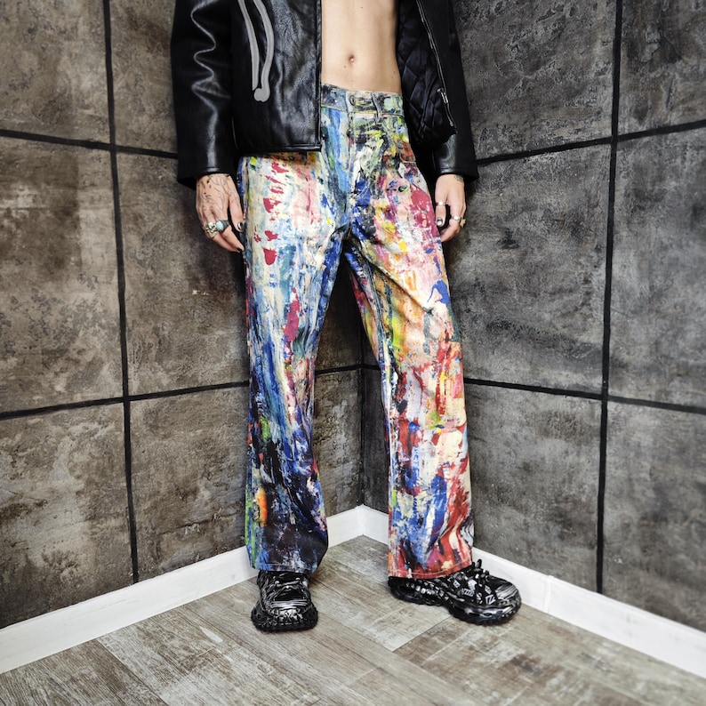 Express your bold style with these unisex paint splatter jeans, featuring vibrant colors and an edgy artistic vibe. Perfect for streetwear fans, skaters, festival goers, and creatives who love standout fashion. These jeans blend comfort with individuality, making them ideal for concerts, parties, raves, or everyday wear. A must-have for Y2K, grunge, and alternative fashion lovers seeking a unique wardrobe staple that turns heads and sets trends.