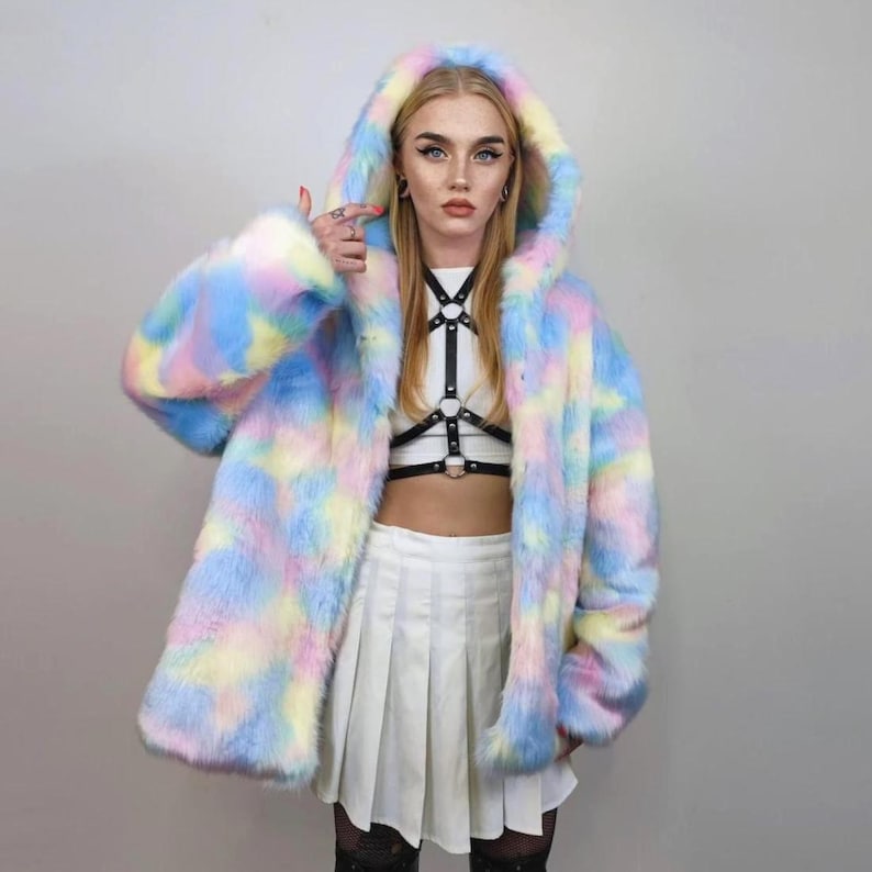 This coat is wearable bliss and pure dopamine dressing! The fluffy tie-dye fleece provides maximum winter warmth and a plush, shaggy texture. Its pastel rainbow blend is ideal for a "Doll Core" aesthetic or standing out on the Playa. This gender-fluid overcoat is your go-to for unique festival wear, blending the comfort of a puffer with the spirit of a raver bomber. The essential pink blue layer for your most whimsical going out looks.