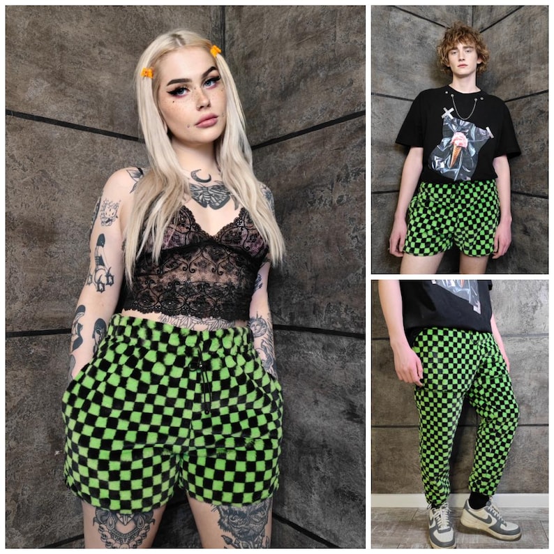 May include: A selection of clothing with a green and black chequered design. The items include shorts and trousers. One person is wearing a black lace top and chequered shorts. Another is wearing a black t-shirt and chequered shorts. A third is wearing chequered trousers.