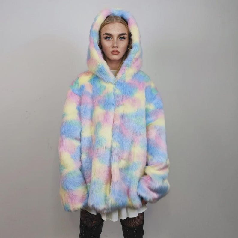 This coat is wearable bliss and pure dopamine dressing! The fluffy tie-dye fleece provides maximum winter warmth and a plush, shaggy texture. Its pastel rainbow blend is ideal for a "Doll Core" aesthetic or standing out on the Playa. This gender-fluid overcoat is your go-to for unique festival wear, blending the comfort of a puffer with the spirit of a raver bomber. The essential pink blue layer for your most whimsical going out looks.