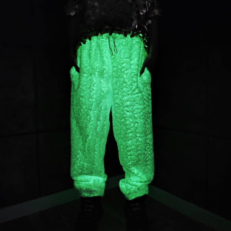 This UV Reactive Parka is the ultimate Cyber Rave statement. Designed for high-impact visibility at warehouse parties and outdoor Festivals, the Bioluminescent effect ensures you stand out in the dark. It features a deep hood for that mysterious "afterhours" look. Pro Tip: Keep the glow strong by standing near a blacklight for a few minutes to "recharge" your brightness throughout the night. Essential gear for Hardstyle, Industrial, and Trance fans.