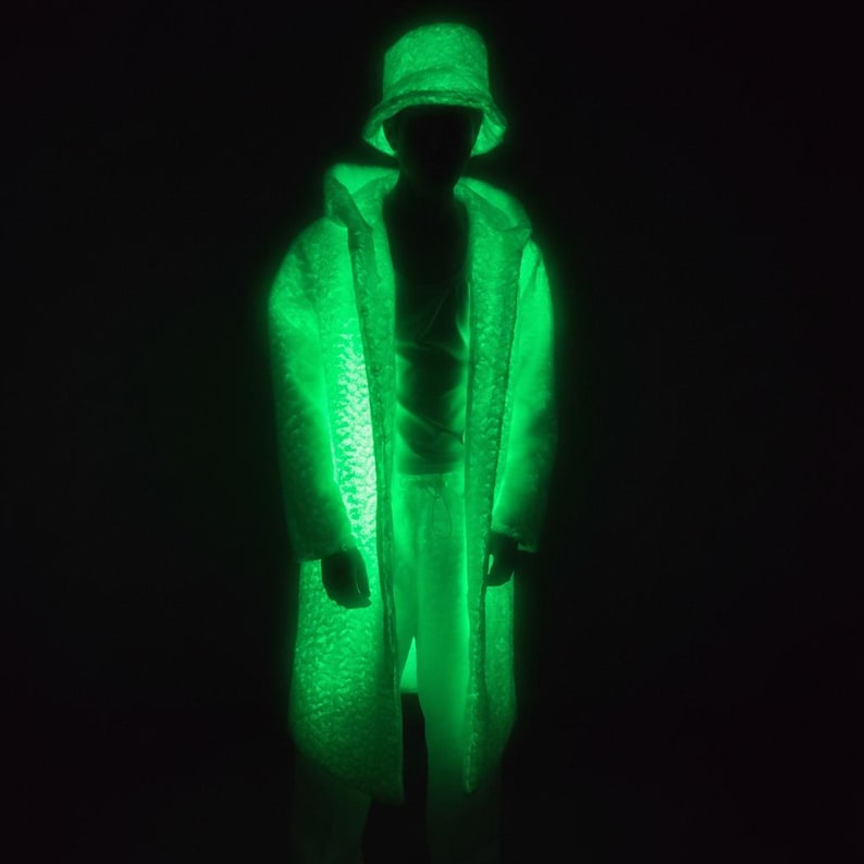 This UV Reactive Parka is the ultimate Cyber Rave statement. Designed for high-impact visibility at warehouse parties and outdoor Festivals, the Bioluminescent effect ensures you stand out in the dark. It features a deep hood for that mysterious "afterhours" look. Pro Tip: Keep the glow strong by standing near a blacklight for a few minutes to "recharge" your brightness throughout the night. Essential gear for Hardstyle, Industrial, and Trance fans.