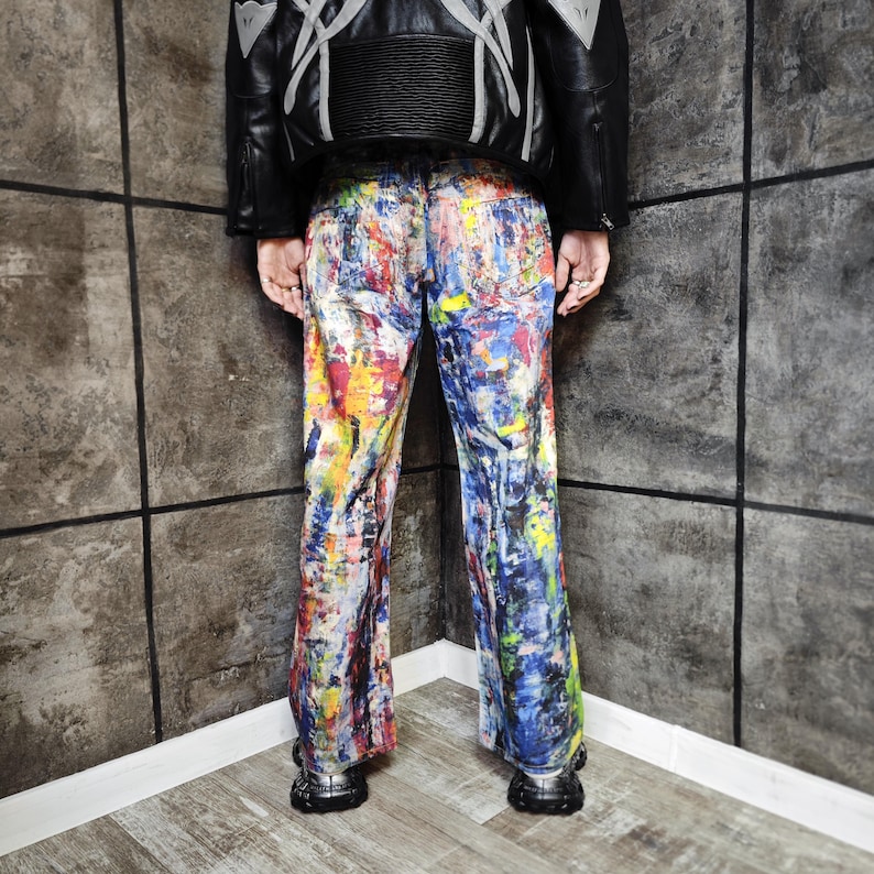 Express your bold style with these unisex paint splatter jeans, featuring vibrant colors and an edgy artistic vibe. Perfect for streetwear fans, skaters, festival goers, and creatives who love standout fashion. These jeans blend comfort with individuality, making them ideal for concerts, parties, raves, or everyday wear. A must-have for Y2K, grunge, and alternative fashion lovers seeking a unique wardrobe staple that turns heads and sets trends.