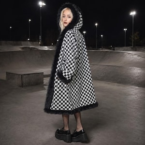 May include: A long coat featuring a black and white checkered pattern, a hood, and black faux fur trim along the hood, cuffs, and hem. The coat is worn with black fishnet stockings and black platform shoes, creating a distinct visual contrast.