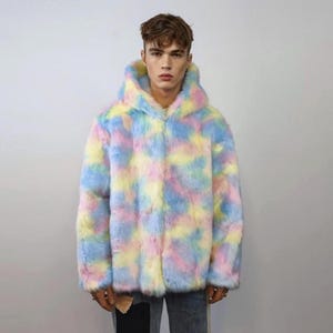 This coat is wearable bliss and pure dopamine dressing! The fluffy tie-dye fleece provides maximum winter warmth and a plush, shaggy texture. Its pastel rainbow blend is ideal for a "Doll Core" aesthetic or standing out on the Playa. This gender-fluid overcoat is your go-to for unique festival wear, blending the comfort of a puffer with the spirit of a raver bomber. The essential pink blue layer for your most whimsical going out looks.