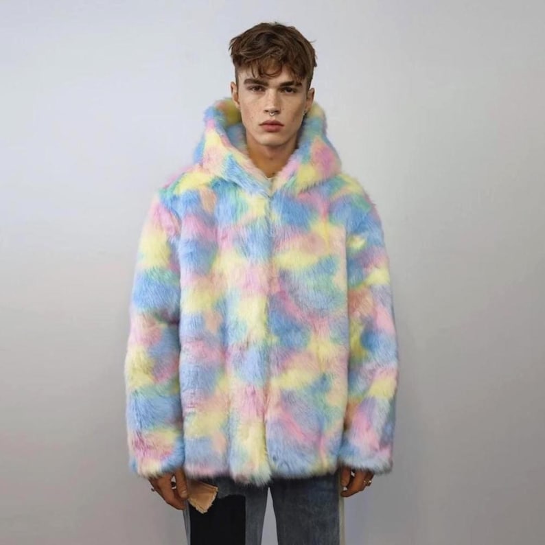 This coat is wearable bliss and pure dopamine dressing! The fluffy tie-dye fleece provides maximum winter warmth and a plush, shaggy texture. Its pastel rainbow blend is ideal for a "Doll Core" aesthetic or standing out on the Playa. This gender-fluid overcoat is your go-to for unique festival wear, blending the comfort of a puffer with the spirit of a raver bomber. The essential pink blue layer for your most whimsical going out looks.