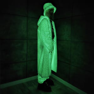 This UV Reactive Parka is the ultimate Cyber Rave statement. Designed for high-impact visibility at warehouse parties and outdoor Festivals, the Bioluminescent effect ensures you stand out in the dark. It features a deep hood for that mysterious "afterhours" look. Pro Tip: Keep the glow strong by standing near a blacklight for a few minutes to "recharge" your brightness throughout the night. Essential gear for Hardstyle, Industrial, and Trance fans.