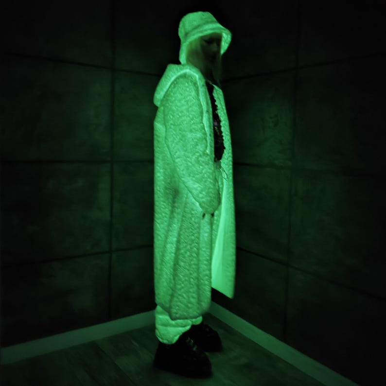 This UV Reactive Parka is the ultimate Cyber Rave statement. Designed for high-impact visibility at warehouse parties and outdoor Festivals, the Bioluminescent effect ensures you stand out in the dark. It features a deep hood for that mysterious "afterhours" look. Pro Tip: Keep the glow strong by standing near a blacklight for a few minutes to "recharge" your brightness throughout the night. Essential gear for Hardstyle, Industrial, and Trance fans.
