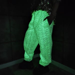 This UV Reactive Parka is the ultimate Cyber Rave statement. Designed for high-impact visibility at warehouse parties and outdoor Festivals, the Bioluminescent effect ensures you stand out in the dark. It features a deep hood for that mysterious "afterhours" look. Pro Tip: Keep the glow strong by standing near a blacklight for a few minutes to "recharge" your brightness throughout the night. Essential gear for Hardstyle, Industrial, and Trance fans.