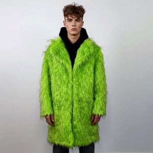 May include: A vibrant, long, lime green faux fur coat with a wide collar. The coat is open, revealing a black hooded sweatshirt. The coat's shaggy texture creates a striking, statement look.