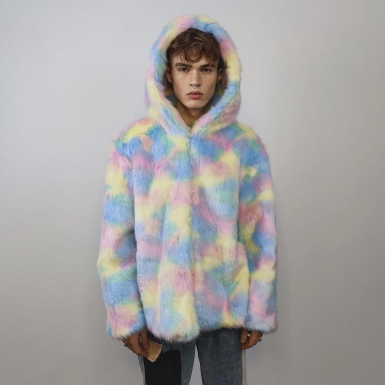 This coat is wearable bliss and pure dopamine dressing! The fluffy tie-dye fleece provides maximum winter warmth and a plush, shaggy texture. Its pastel rainbow blend is ideal for a "Doll Core" aesthetic or standing out on the Playa. This gender-fluid overcoat is your go-to for unique festival wear, blending the comfort of a puffer with the spirit of a raver bomber. The essential pink blue layer for your most whimsical going out looks.