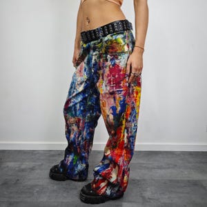 Express your bold style with these unisex paint splatter jeans, featuring vibrant colors and an edgy artistic vibe. Perfect for streetwear fans, skaters, festival goers, and creatives who love standout fashion. These jeans blend comfort with individuality, making them ideal for concerts, parties, raves, or everyday wear. A must-have for Y2K, grunge, and alternative fashion lovers seeking a unique wardrobe staple that turns heads and sets trends.