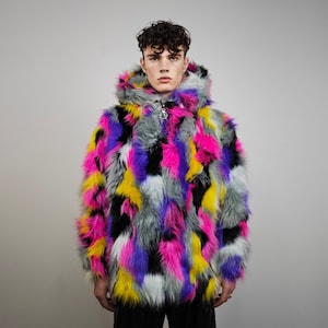 May include: A hooded faux fur jacket in a patchwork of vibrant colors: pink, yellow, purple, black, gray, and white. The jacket has a zipper closure and a soft, textured appearance. A statement piece for a bold look.