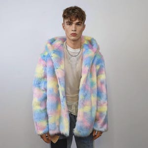 This coat is wearable bliss and pure dopamine dressing! The fluffy tie-dye fleece provides maximum winter warmth and a plush, shaggy texture. Its pastel rainbow blend is ideal for a "Doll Core" aesthetic or standing out on the Playa. This gender-fluid overcoat is your go-to for unique festival wear, blending the comfort of a puffer with the spirit of a raver bomber. The essential pink blue layer for your most whimsical going out looks.
