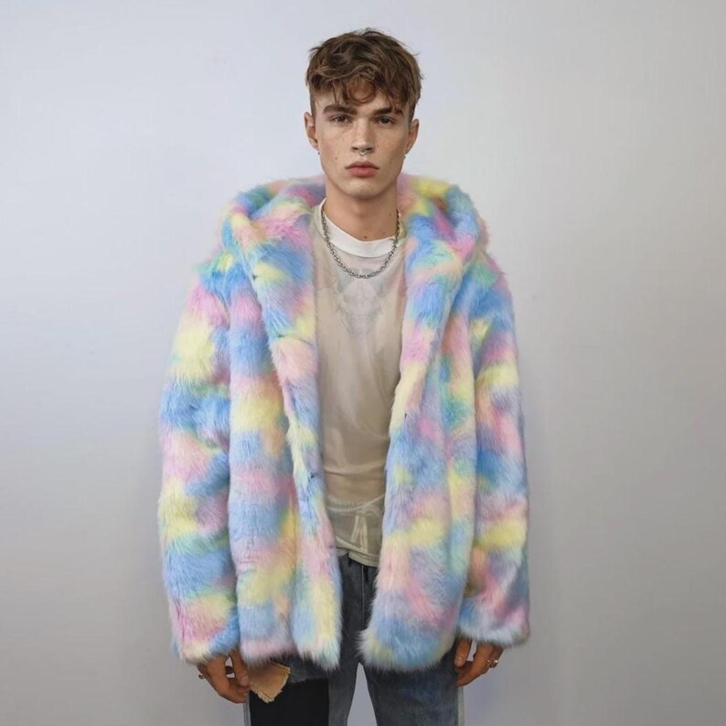 This coat is wearable bliss and pure dopamine dressing! The fluffy tie-dye fleece provides maximum winter warmth and a plush, shaggy texture. Its pastel rainbow blend is ideal for a "Doll Core" aesthetic or standing out on the Playa. This gender-fluid overcoat is your go-to for unique festival wear, blending the comfort of a puffer with the spirit of a raver bomber. The essential pink blue layer for your most whimsical going out looks.