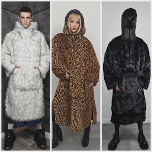May include: Three full-length faux fur coats. One is white, one is leopard print, and the third is black. Each coat has a hood and pockets. The models are wearing boots.