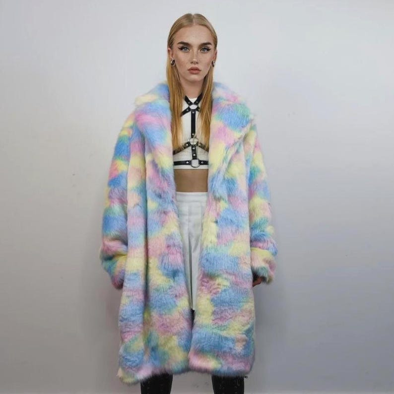 Step into a fantasy with this spectacular Pastel Faux Fur Long Unicorn Coat! The voluminous, fluffy fur features a magical, tie-dye rainbow of soft pinks, blues, and yellows. The dramatic long trench silhouette and oversized fit make it perfect for commanding attention. This unisex piece is your essential layer for Burner events, raver nights, and festival days. It’s the ultimate fluffy fleece jacket for a bold, maximalist statement.