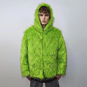 May include: A bright green, furry hooded jacket. The jacket has a button-up front and a hood that frames the face. The material appears to be long, shaggy faux fur. The jacket is a vibrant, eye-catching piece of clothing.