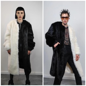 May include: Two long faux fur coats, one black and white, the other white and black. The coats are split down the middle with one side black and the other white. The coats are worn by two people.
