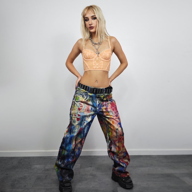Express your bold style with these unisex paint splatter jeans, featuring vibrant colors and an edgy artistic vibe. Perfect for streetwear fans, skaters, festival goers, and creatives who love standout fashion. These jeans blend comfort with individuality, making them ideal for concerts, parties, raves, or everyday wear. A must-have for Y2K, grunge, and alternative fashion lovers seeking a unique wardrobe staple that turns heads and sets trends.